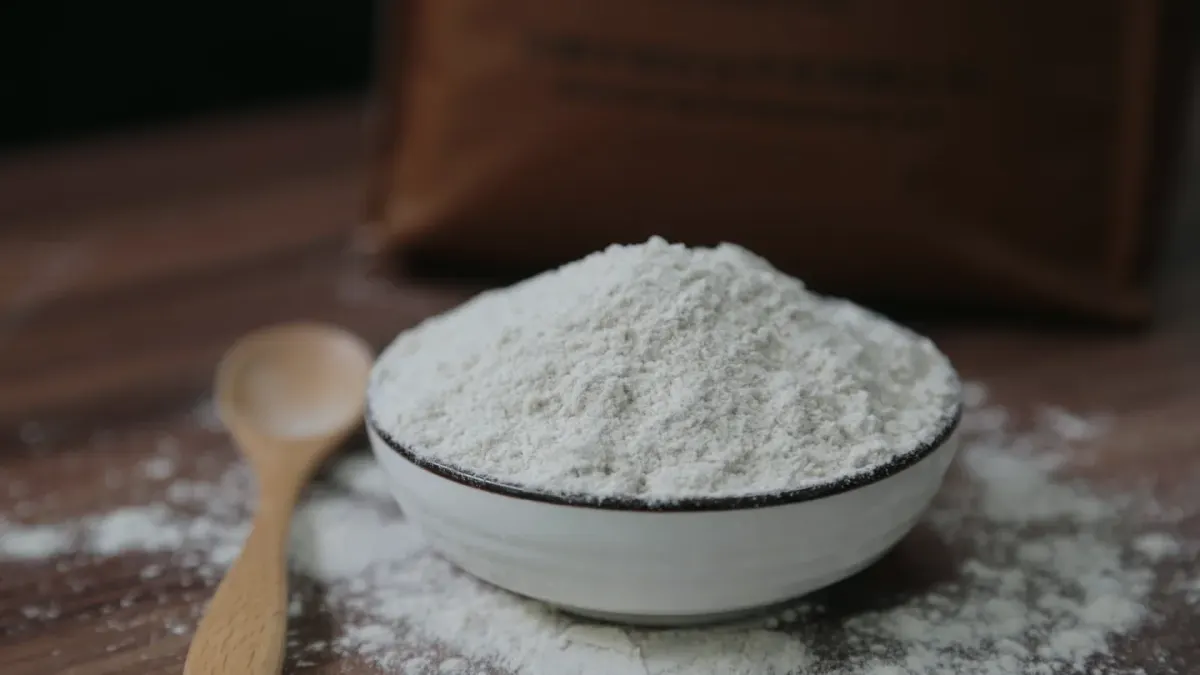 A measuring scoop of pale powder set beside a dog's food bowl