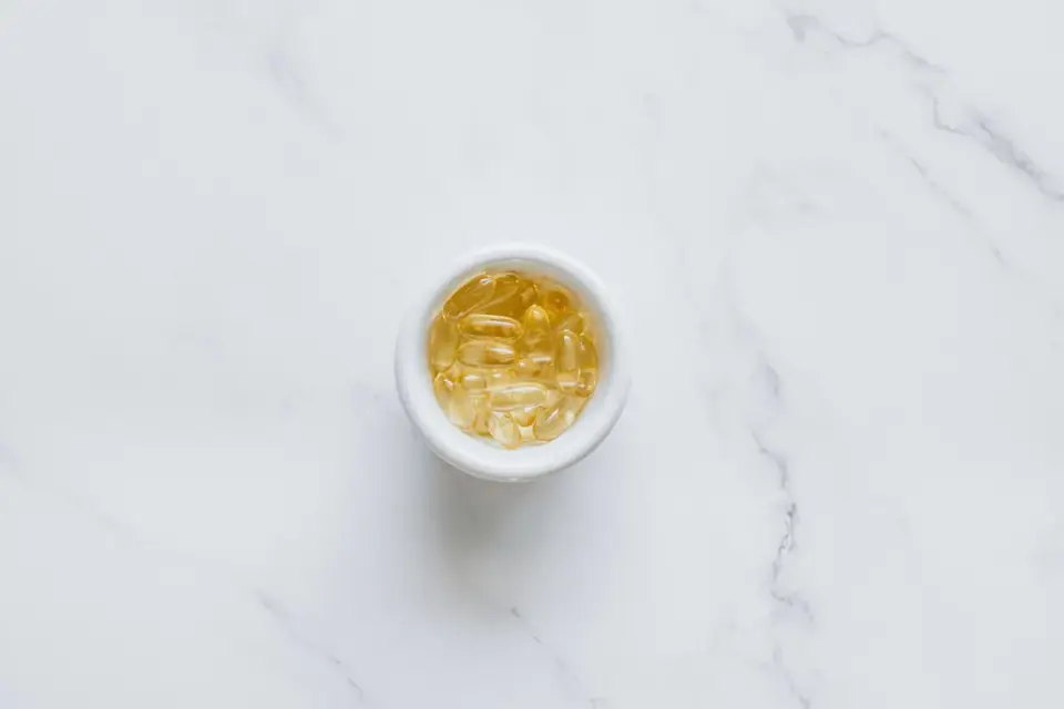 A small bowl of soft chew supplements sitting beside a dog&#x27;s food bowl