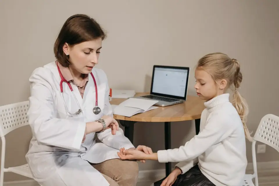 A veterinarian gently examining a puppy on an exam table