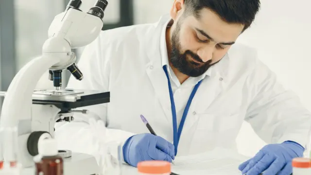A veterinarian preparing a fecal sample slide for microscopic examination