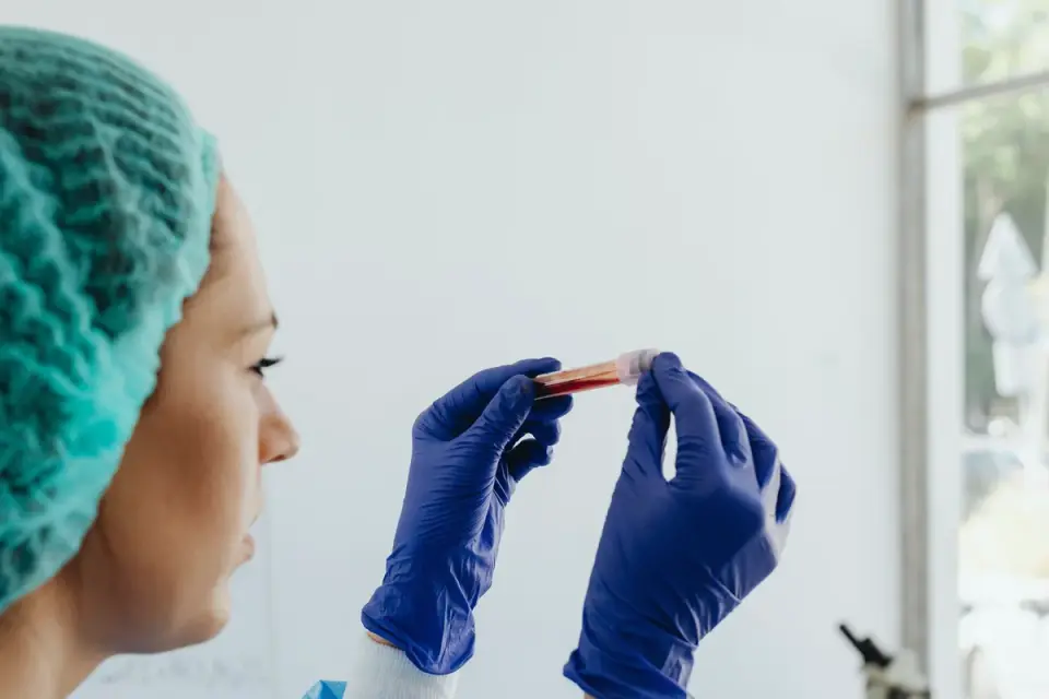 A veterinarian preparing a fecal sample to check a puppy for parasites