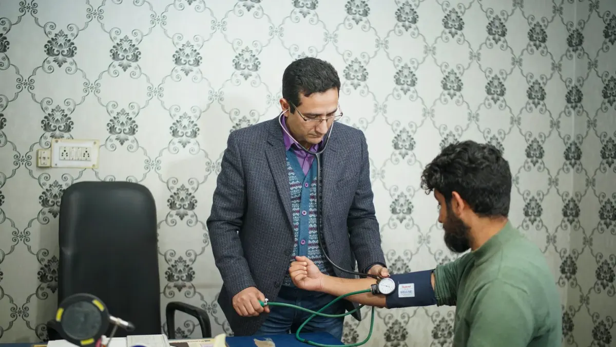 A veterinarian reviewing a dog's diet and stool notes with the owner during an exam