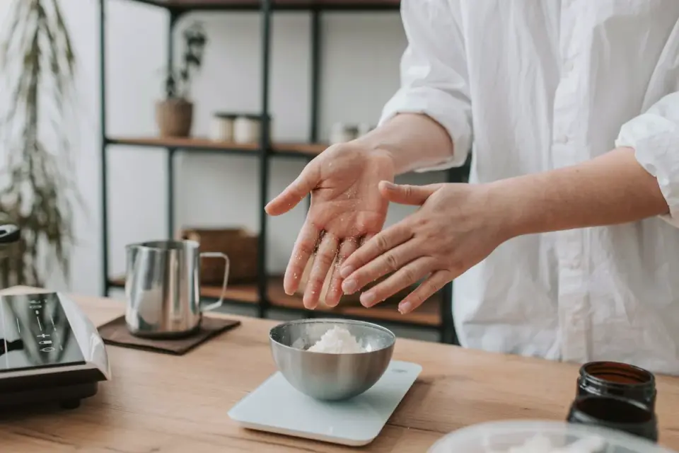 An owner portioning soft chews into a small bowl on a kitchen counter