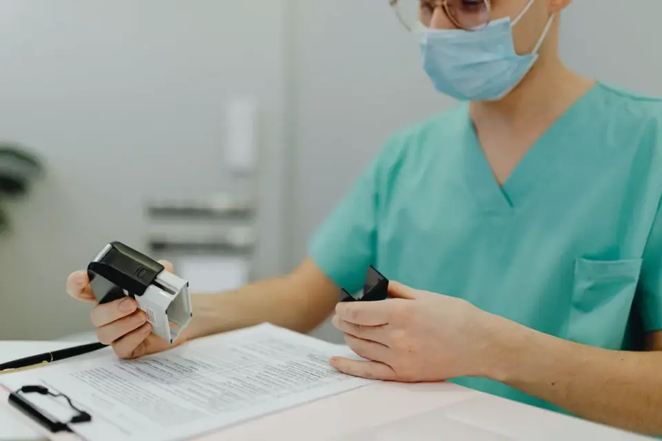 Veterinarian reading a supplement label while a dog waits on the exam table